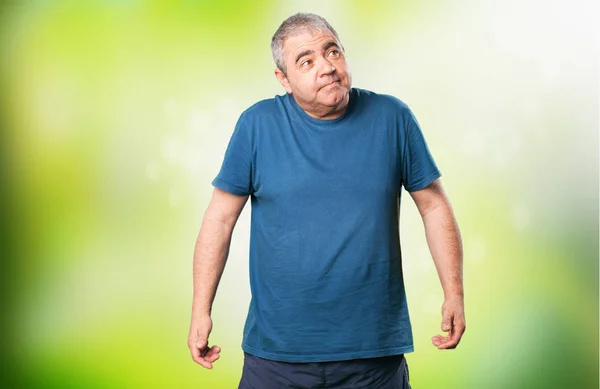 Mature Man Doubting Green Blurred Background — Stock Photo, Image