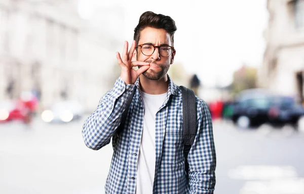 student man doing silence gesture