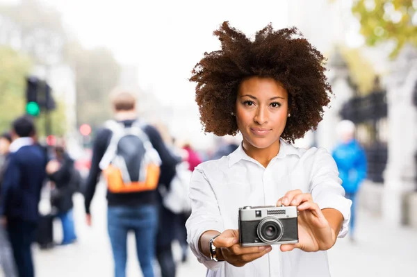 背景をぼかした写真にビンテージ カメラを使用して若い黒人女性 — ストック写真