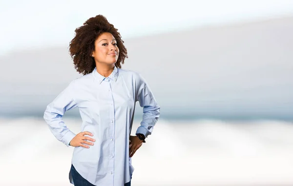 young black woman standing on blurred background