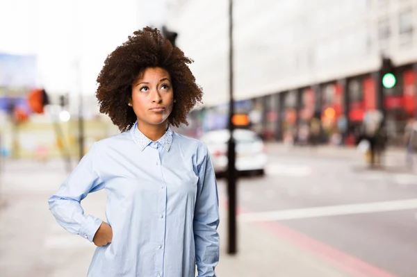 young black woman thinking on blurred background
