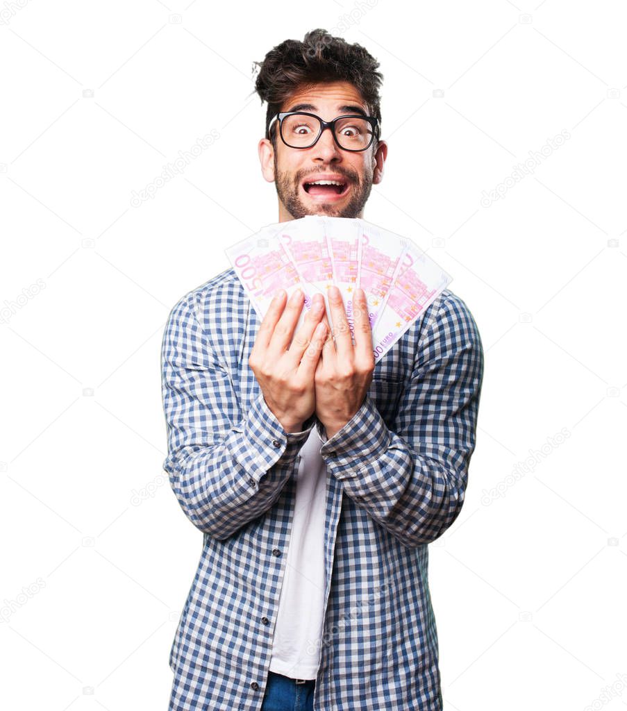 happy young man holding bills isolated on white background