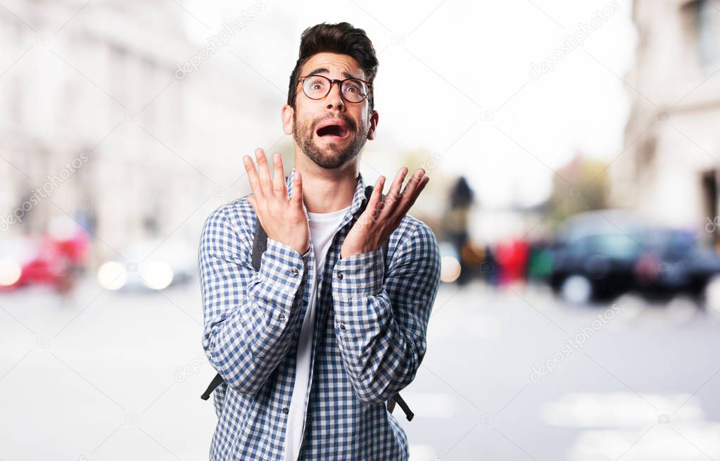 afraid young man on blurred background