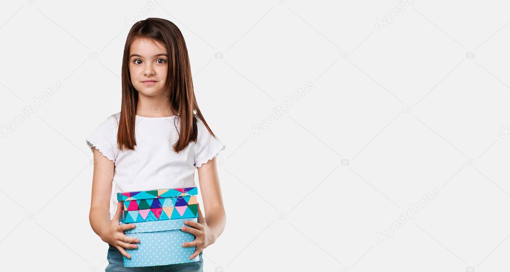 Full body little girl cheerful and calm, holding some boxes in vintage style