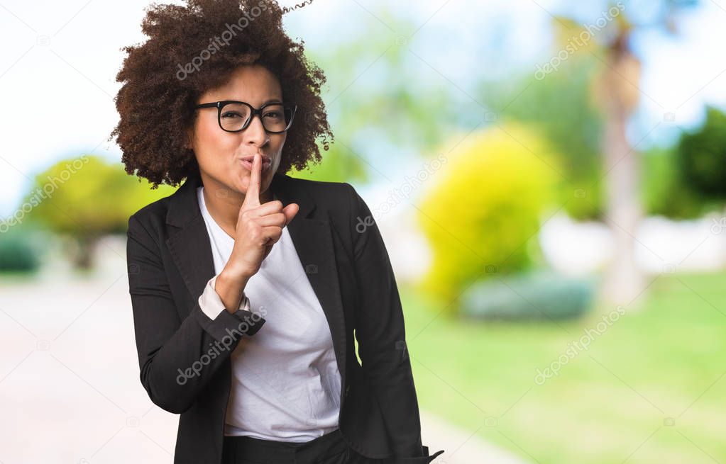 business black woman doing silence gesture