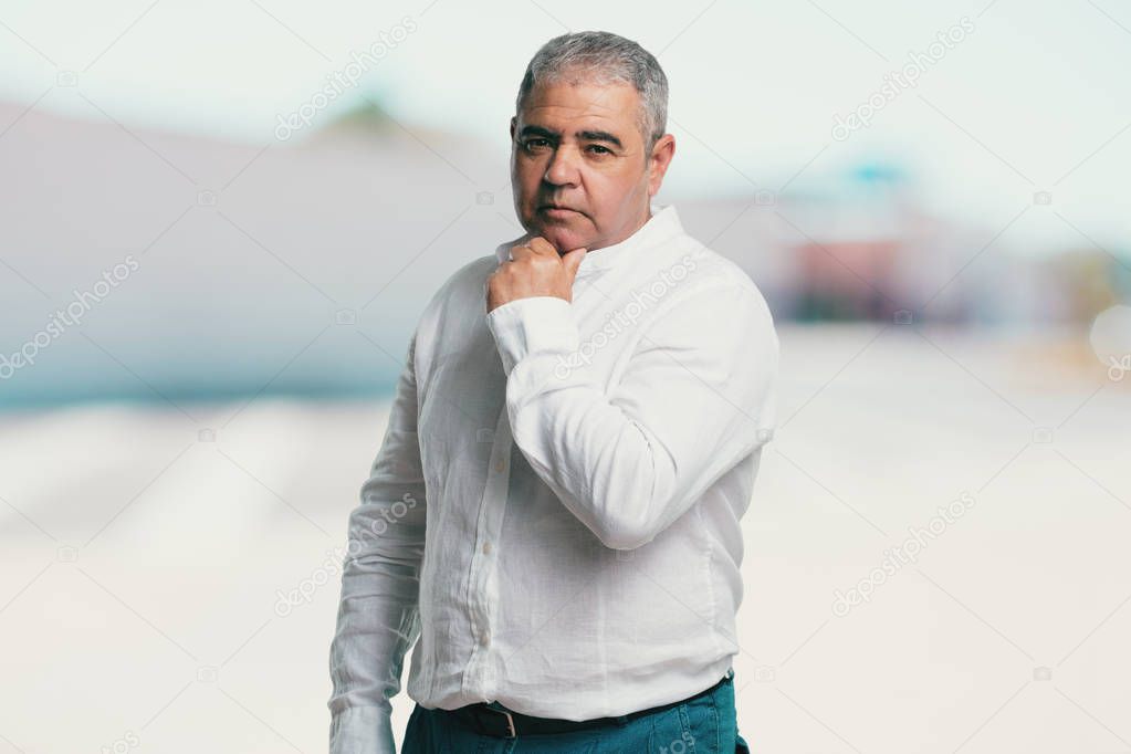 Middle aged man thinking and looking up, confused about an idea, would be trying to find a solution