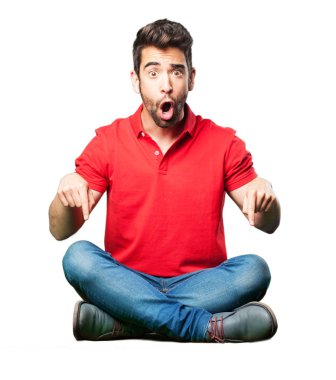 şaşırmış adam oturma izole üzerinde beyaz arka plan işaret.