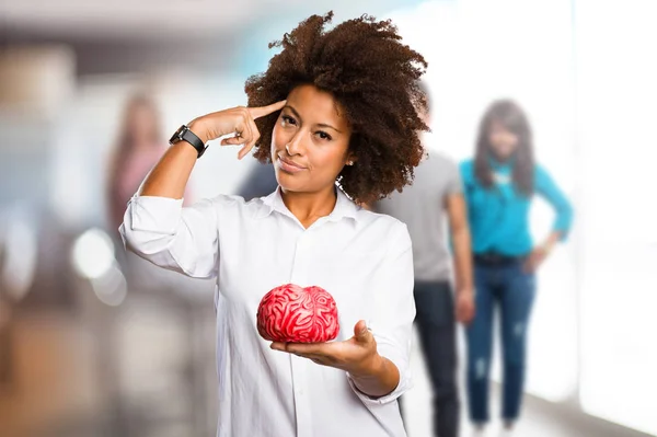 Young Black Woman Holding Brain Shape Blurred People Background — Stock Photo, Image