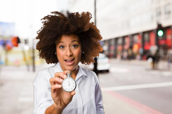 Jonge Zwarte Vrouw Met Een Stopwatch Onscherpe Achtergrond — Stockfoto