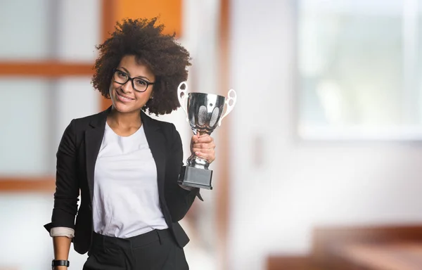 business black woman holding trophy