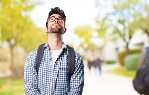 pensive young man on blurred background