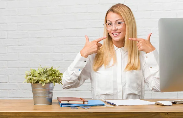 Portrait Young Student Sitting Her Desk Doing Tasks Smiles Pointing Stock Image