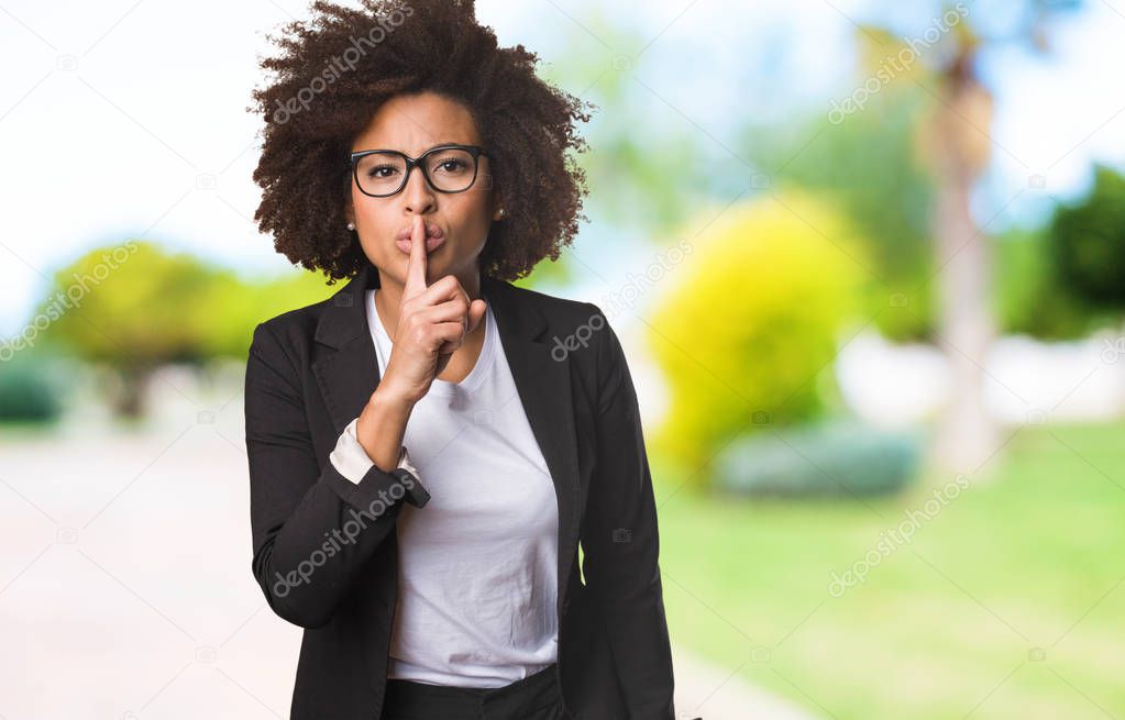 business black woman doing silence gesture