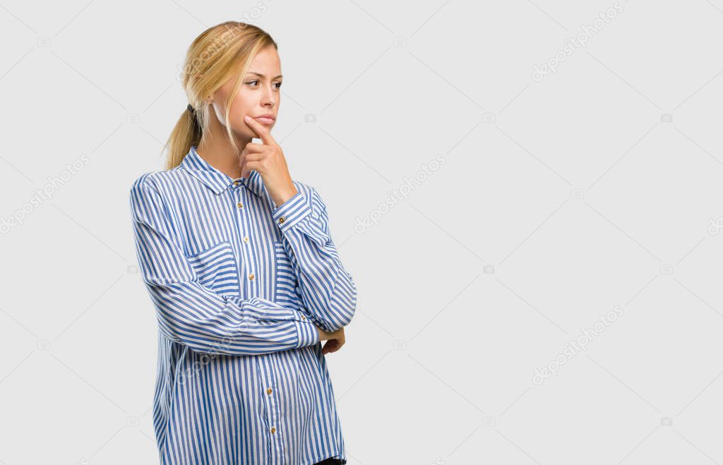 Portrait of young pretty blonde woman doubting and confused