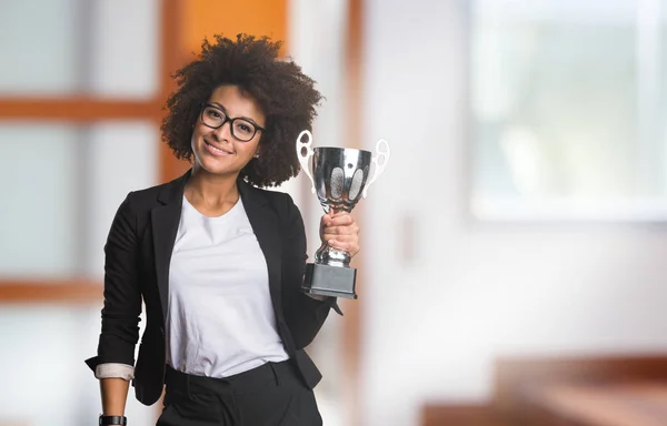 business black woman holding trophy