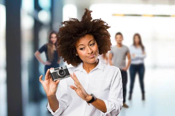 Young Black Woman Using Vintage Camera Blurred People Background — Stock Photo, Image