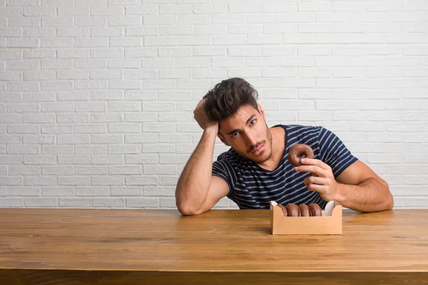 Young Handsome Natural Man Sitting Table Worried Overwhelmed Forgetful Realize — Stock Photo, Image