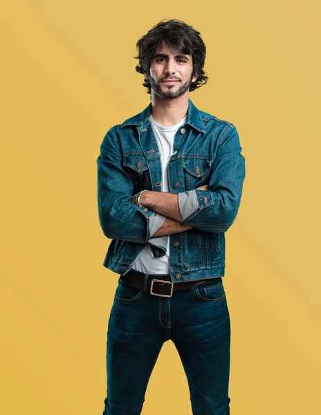 Young handsome man crossing his arms, smiling and happy, being confident and friendly