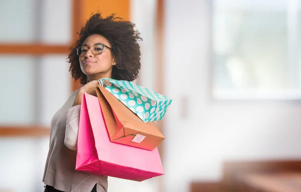 black woman holding shopping bags