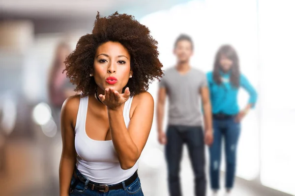 Young Black Woman Sending Kisses Blurred People Background — Stock Photo, Image