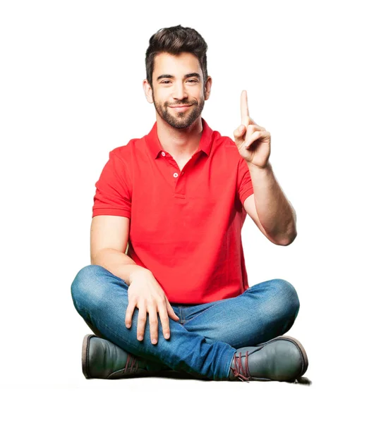 Man Sitting Doing Number One Gesture Isolated White Background — Stock Photo, Image