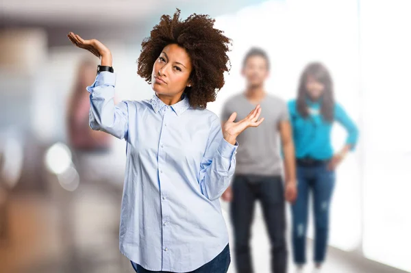 young black woman doubting with blurred people in background