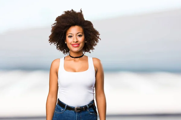 young black woman standing on blurred background