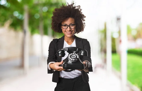 black business woman holding a telephone on blurred background
