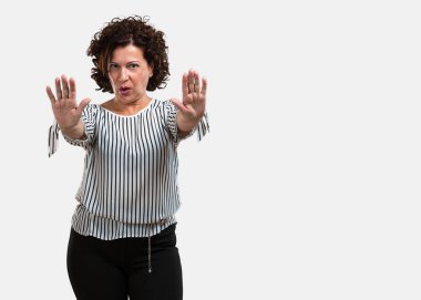 Orta yaşlı kadın ciddi ve kararlı, önünde el koyarak, jest durdurmak, kavram izin verme