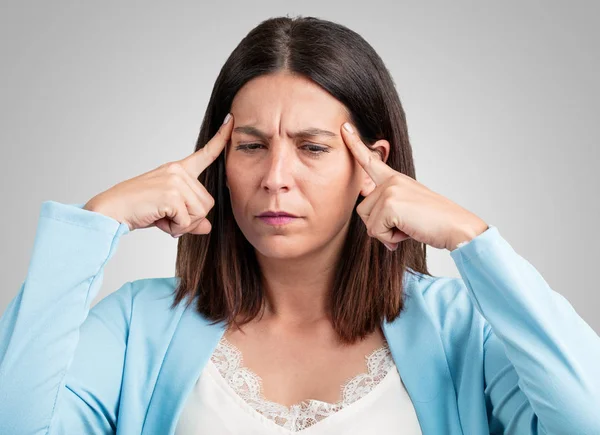 Middle aged woman man making a concentration gesture, looking straight ahead focused on a goal