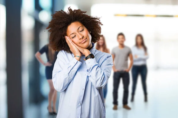 young black woman sleeping with blurred people in background