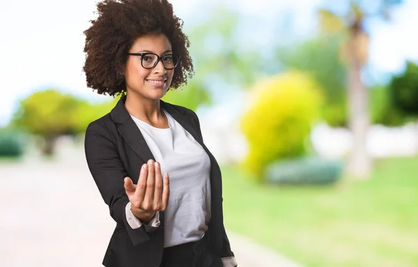 black business woman inviting someone to come on blurred background
