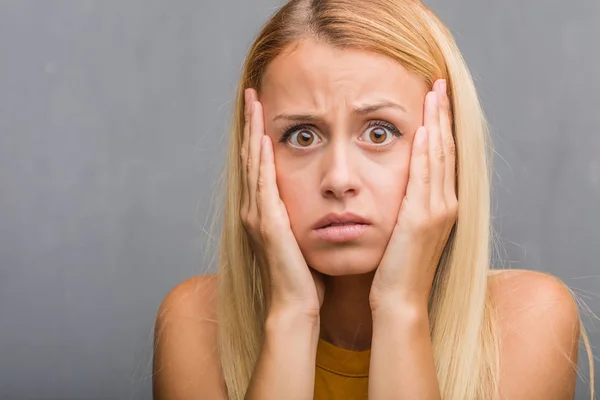 portrait of natural young blonde woman frustrated and desperate