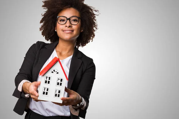 Black Business Woman Holding Small House Gray Background — Stock Photo, Image