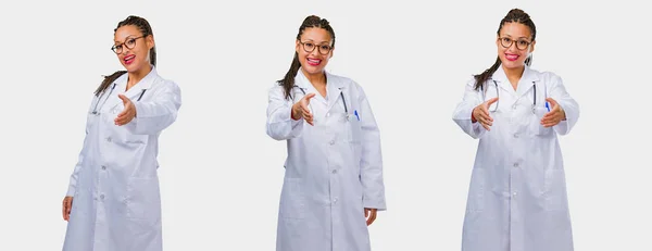 Set of young black female doctor reaching out to greet someone on gray background