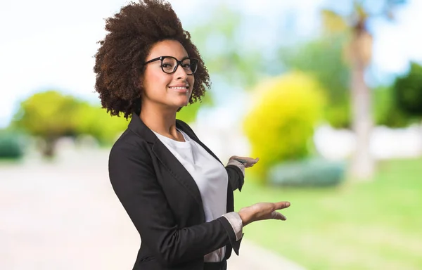 business black woman doing welcome gesture