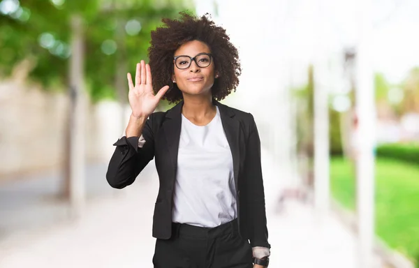 black business woman doing stop gesture on blurred background