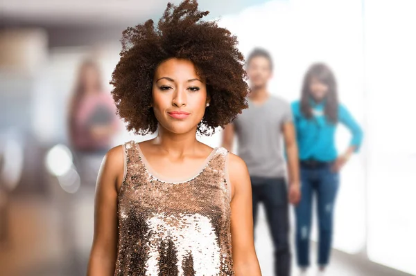 young black woman standing with blurred people in background