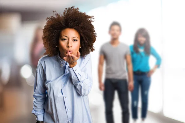 Young Black Woman Sending Kiss Blurred People Background — Stock Photo, Image