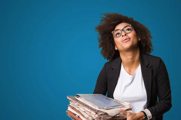 black business woman holding files on blue background