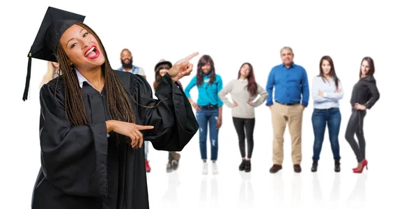 Jovem Graduada Mulher Negra Vestindo Tranças Apontando Para Lado Sorrindo — Fotografia de Stock