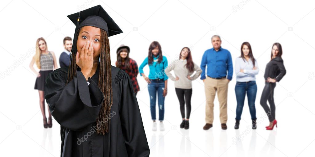 Young graduated black woman wearing braids very scared and afraid, desperate for something, cries of suffering and open eyes, concept of madness
