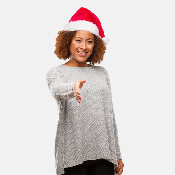 年轻的黑人妇女戴着圣诞老人的帽子伸手去迎接某人 — 图库照片
