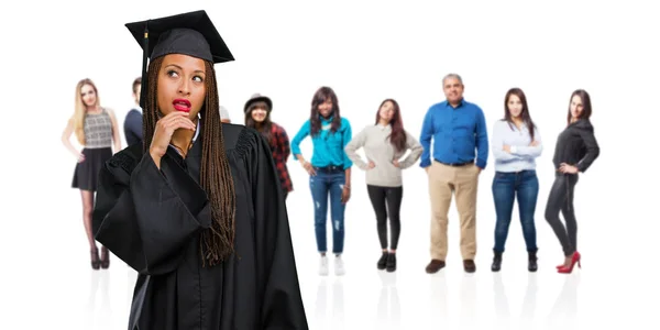 Young Graduated Black Woman Wearing Braids Doubting Confused Thinking Idea — Stock Photo, Image