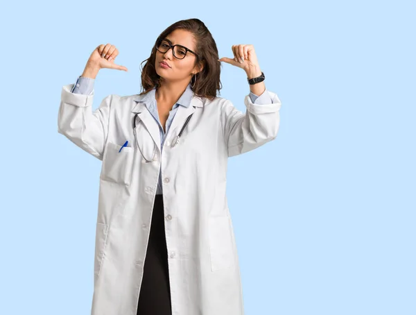 Full body young doctor woman pointing fingers, example to follow