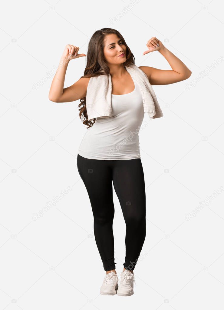 Full body young fitness curvy woman pointing fingers, example to follow