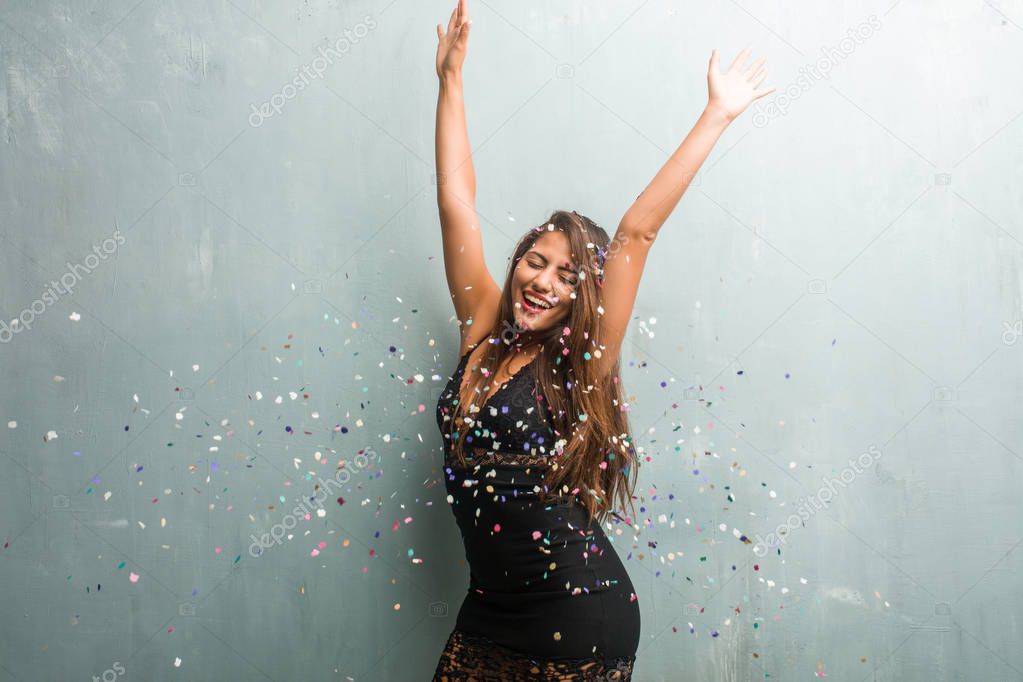 Young latin woman celebrating new year or an event. Very happy a