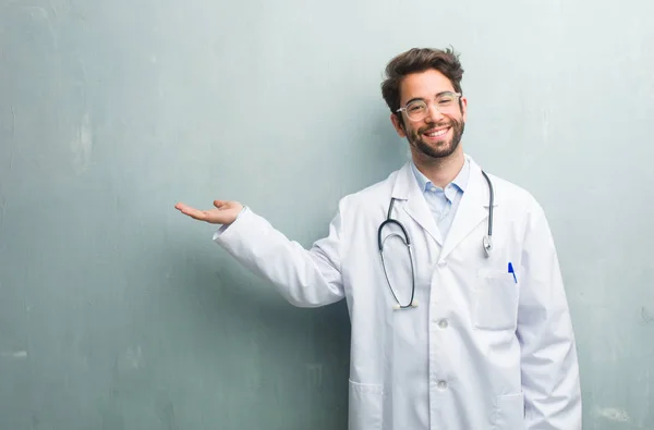 Young Friendly Doctor Man Grunge Wall Copy Space Holding Something — Stock Photo, Image
