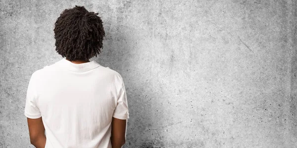 Handsome african american showing back, posing and waiting, looking back