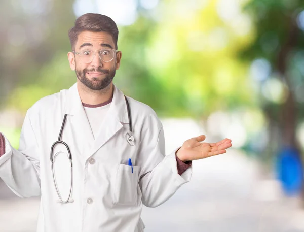Young doctor man confused and doubtful